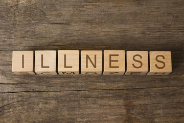 Fototapeta premium Healthcare concept: word illness written on wooden cubes