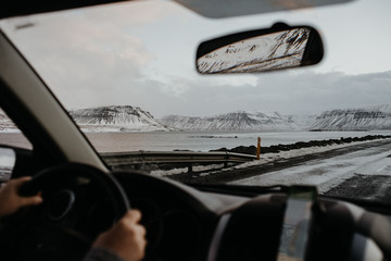 Looking at an Icelandic landscape through the front window of a car.