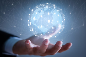 Hand of businessman holding abstract globe with connections. Global business concept.