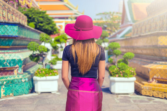 rear view of a Thai women visiting the temple of Wat Pho in Bangkok in day , Thailand , Southeast asia . . 