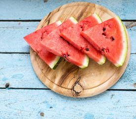 slices of watermelon on wooden table