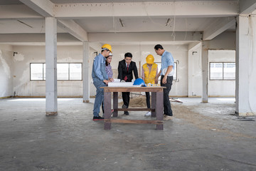 Businessman working with Architect  Engineer in building Construction Site with blueprint.Checking project plan.