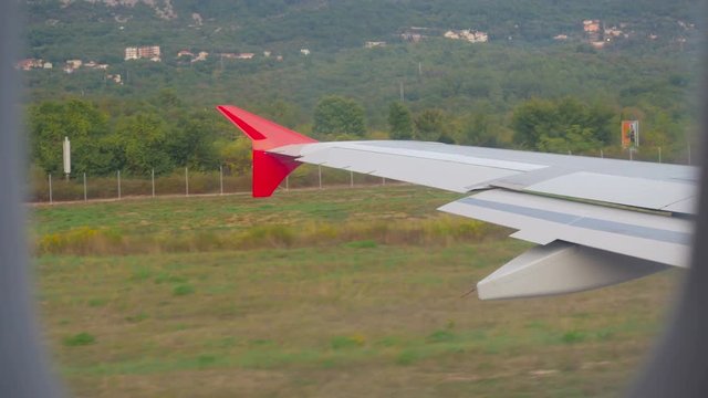 wing of the aircraft accelerates on the ground on the runway in Montenegro