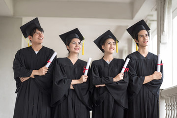 Graduation day, Row of Happily graduates are celebrating graduation, a certificate in hand, Happiness feeling, Commencement day, Congratulation.