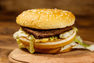 Delicious big hamburger on wooden table