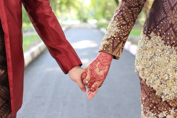 muslim bride holding hands