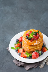 Stack of homemade pancakes for breakfast with berries