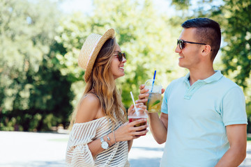 Young couple drinking cocktails, spending time outdoors