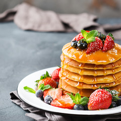 Stack of homemade pancakes for breakfast with berries