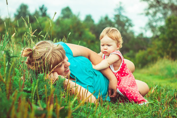 grandmother with granddaughter on the grass