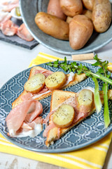 slices of ham and potatoes in blue dish