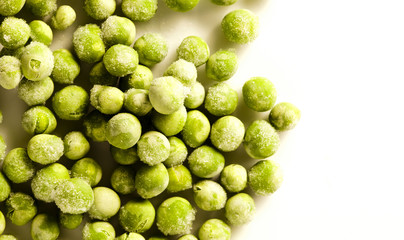 Frozen Peas on white surface
