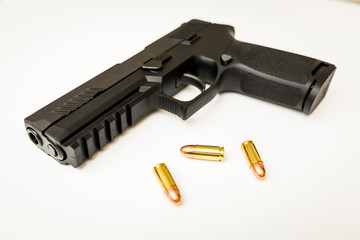 Handgun with ammo rounds and smoke