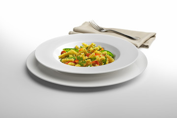 Pasta dish Fusilli and vegetables with napkin and fork