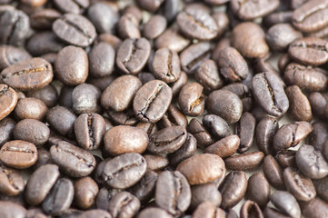 Roasted coffee beans background, coffee seeds, berries from the coffea plant