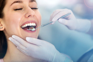 Woman having teeth examined at dentists
