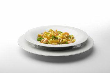 Pasta dish Penne with shrimps and vegetables