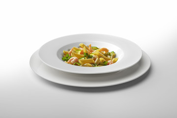 Pasta dish Penne with shrimps and vegetables