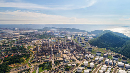 Aerial view Oil refinery with a background of mountains and sky.