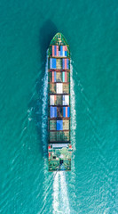 Container ship in export and import business and logistics. Shipping cargo to harbor by crane. Water transport International. Aerial view