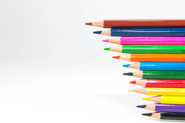 Color pencils row close up shot isolated on white background.