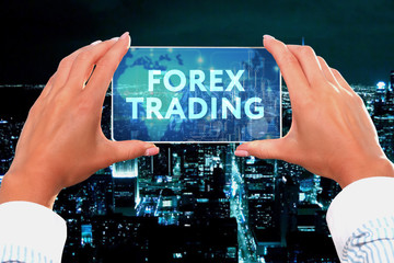 The concept of business, technology, the Internet and the network. Business lady looks at the virtual screen of your smartphone and sees the inscription: Forex trading