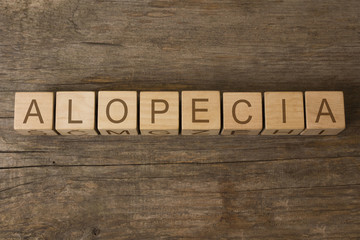 alopecia word written on wooden cubes