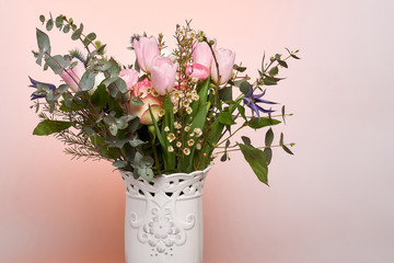 A colorful bouquet of spring flowers in white vase