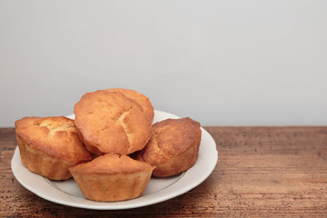 plate with cupcakes on white background
