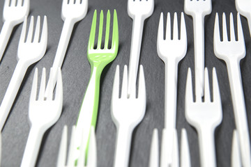 Plastic fork white and a green in between