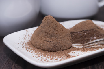 Dessert truffle on white plate.