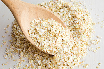 rolled oats in big wooden spoon