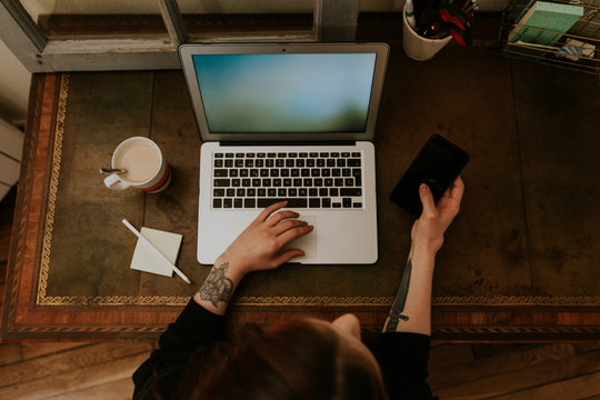 Young Woman Typing On Laptop