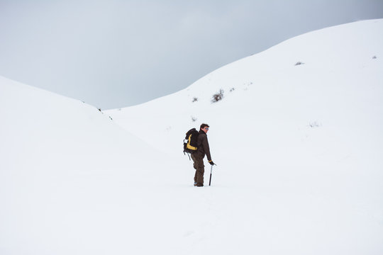 Tourist walking on snowy mountain