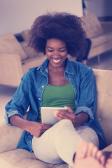 african american woman at home with digital tablet