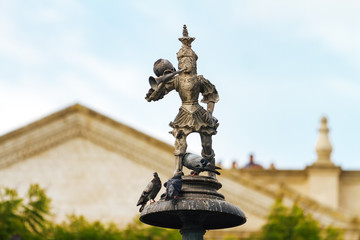 Fototapeta premium Close up of statue of Tuturutu (Elf with trumpet) with pigeons in the Plaza de Armas