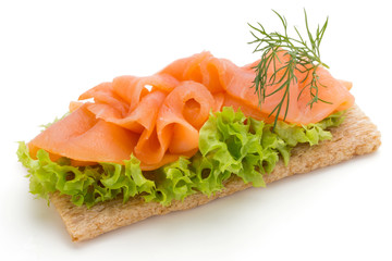 Bread with fresh salmon fillet isolated on white background, top view.