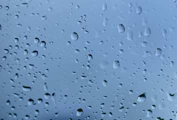 Glass with drops of the rain with blue color
