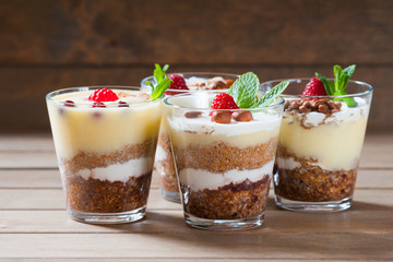 Dessert with berries, jelly, cream, nuts and mint leaf 