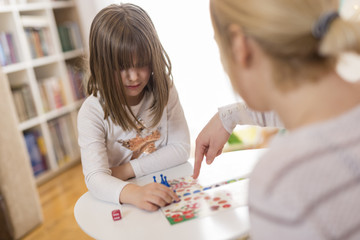 Mother and daughter playing ludo board game © Impact Photography