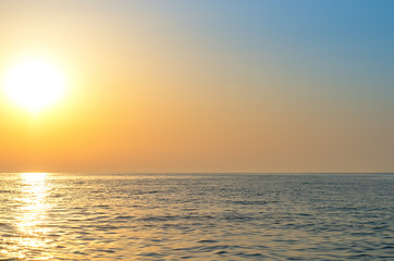 sunrise over the sea horizon, reflections on the water, waves