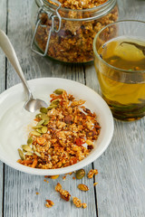 Granola Breakfast with yogurt in a plate and herbal tea