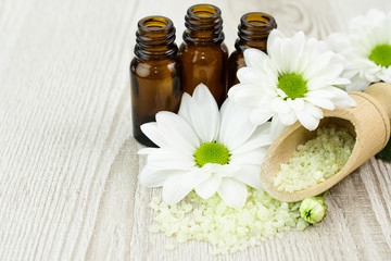 Spa still life with blossoms of chrysanthemum white and essential oils.