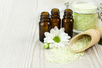 Spa still life with blossoms of chrysanthemum white and essential oils.