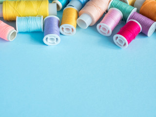 Multicolored sewing buttons on blue background with copy space flat clutch