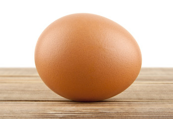 chicken egg on a wooden table isolated on a white background