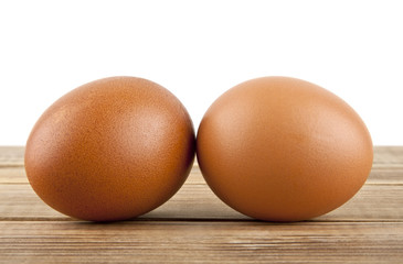 chicken egg on a wooden table isolated on a white background