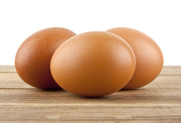 chicken egg on a wooden table isolated on a white background