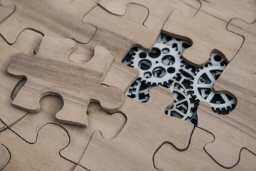 gears under the pieces of the puzzle, the concept of moving to the next level. Business idea,...