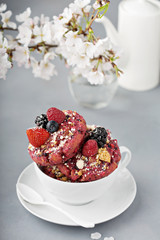 Berry shortcake donuts in a white cup
